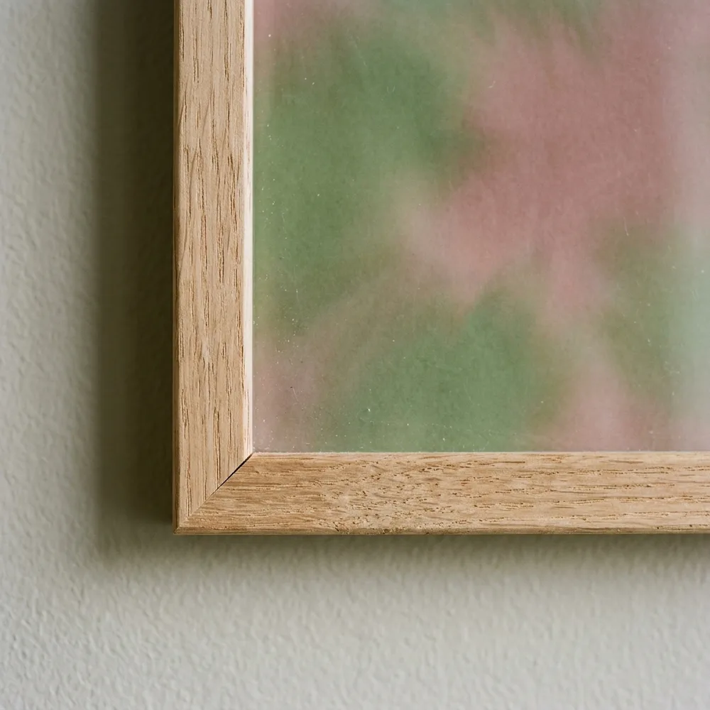 The quiet mitre of a plain wood frame, the sheet full to the edge
